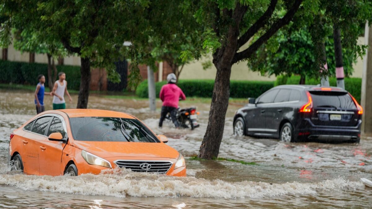 A group of people walking through a flooded street